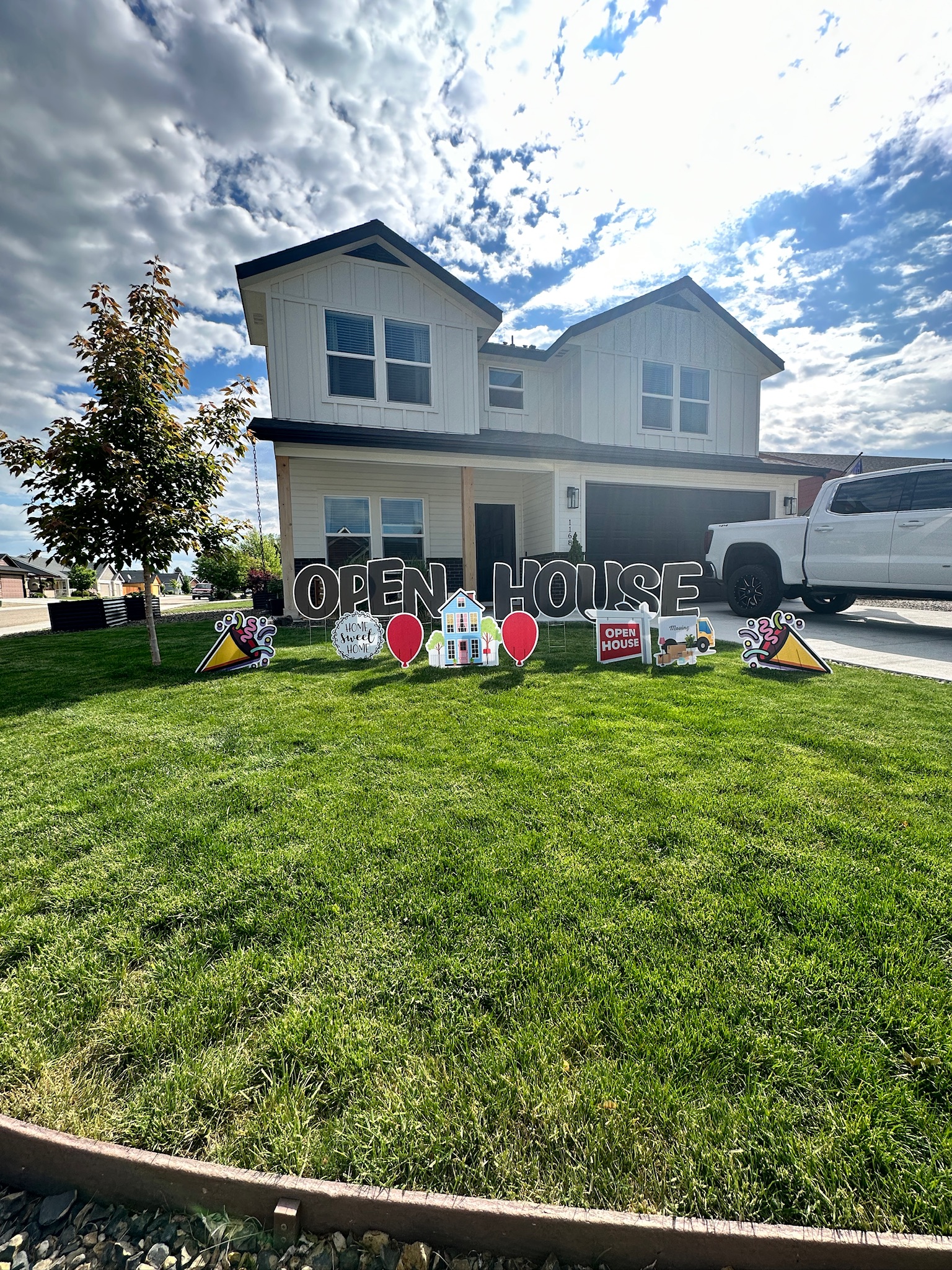 Open house black yard card display with elegant for sale and welcome signage in Boise Idaho