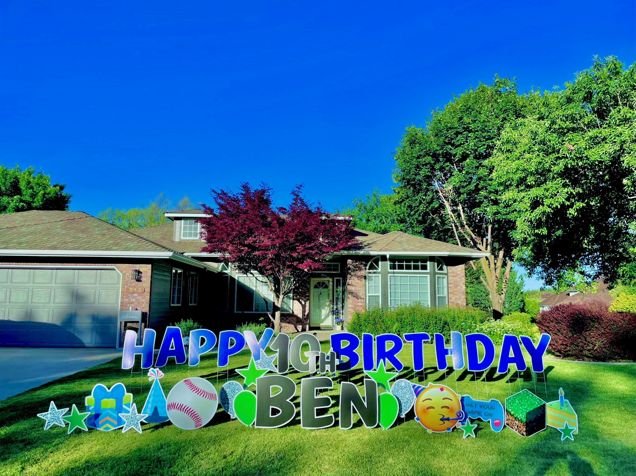 Happy 10th Birthday Ben yard card display with colorful letters and sports art on a Boise Idaho lawn