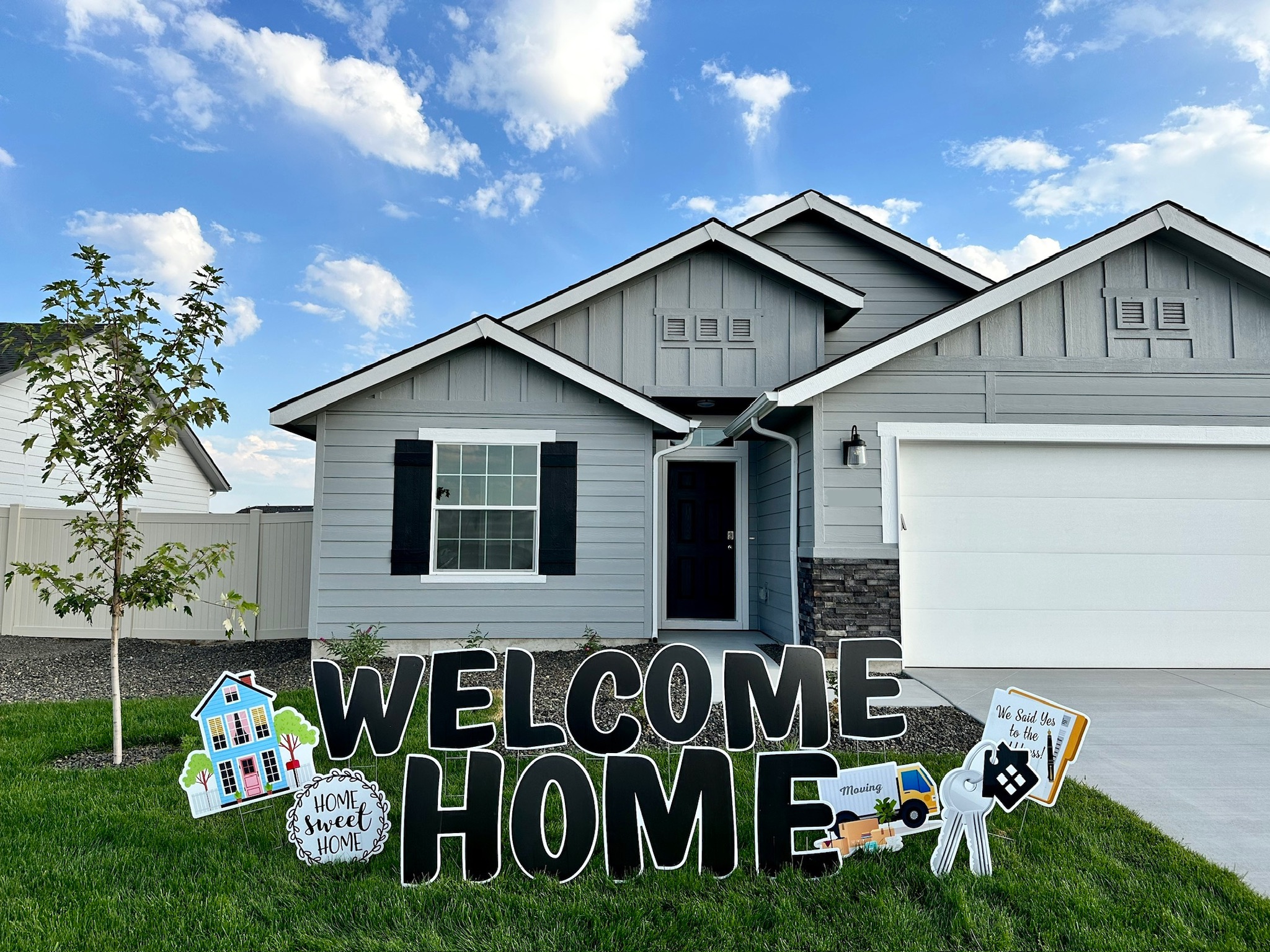 Welcome Home black yard card display with elegant lettering and house art in Boise Idaho