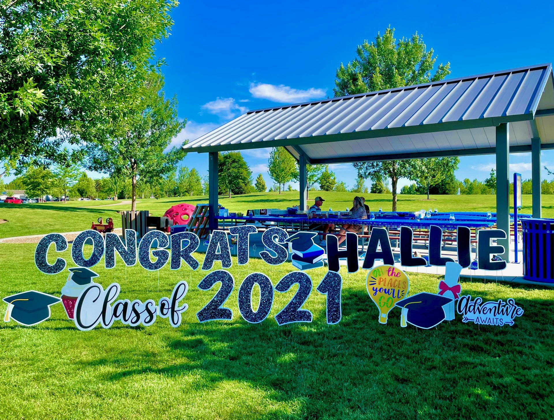 Congrats Hallie Class of 2021 graduation yard card display with glitter letters and cap art at a Boise Idaho park