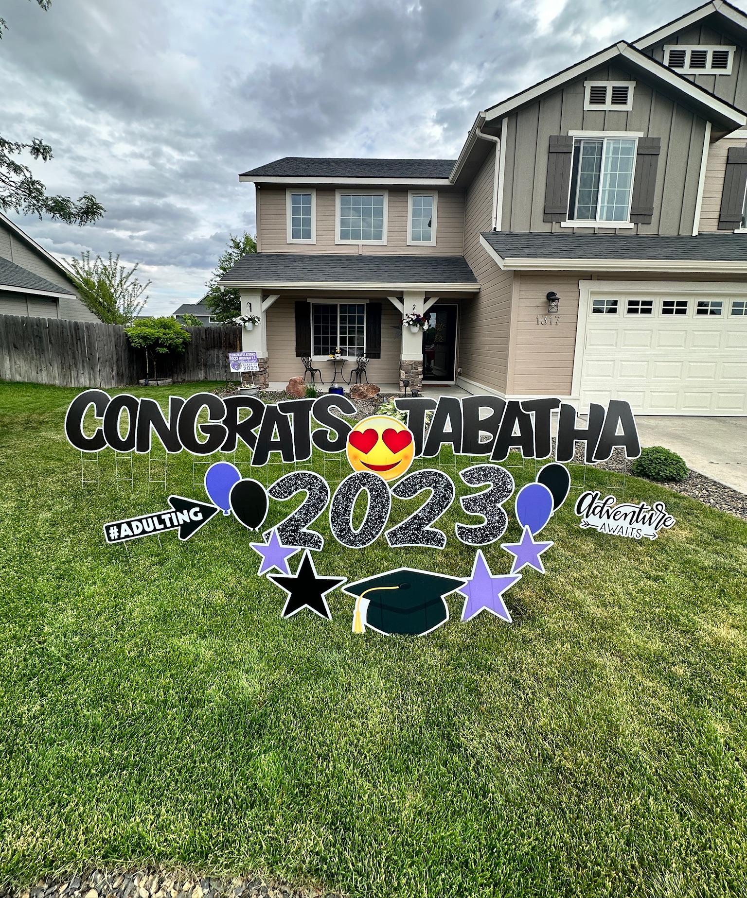 Congrats Tabatha 2023 graduation yard card display with bold black glitter letters and purple star art in Boise Idaho