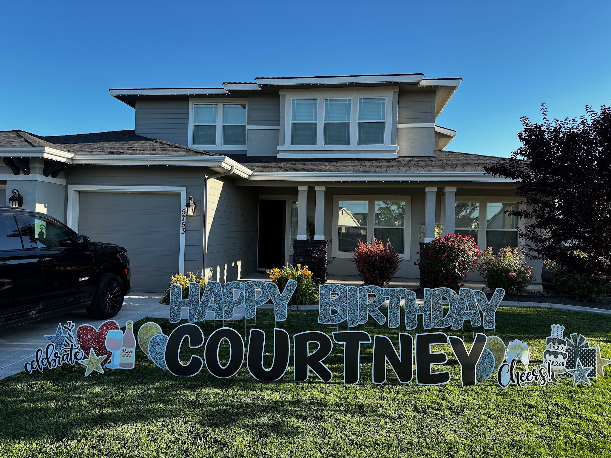 Happy Birthday Courtney yard card display with black glitter letters and celebration art at golden hour in Boise Idaho