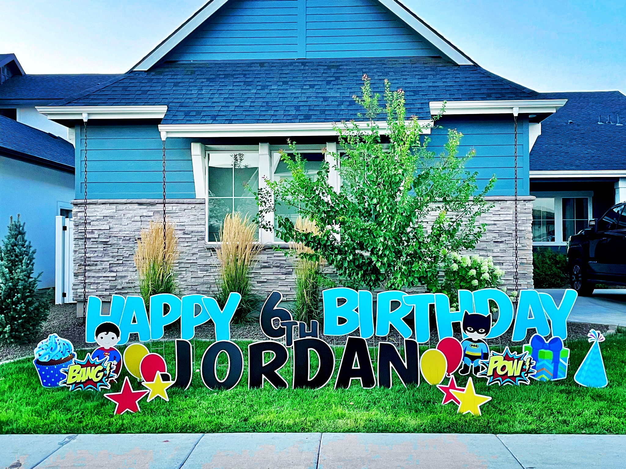 Happy 6th Birthday Jordan yard card display with Batman superhero letters and colorful party art in Boise Idaho
