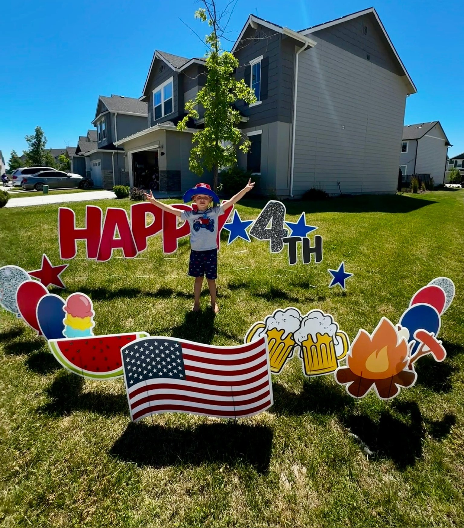 Happy 4th of July yard card display with flag, watermelon, and festive art by Hooray Yard Cards Boise